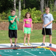 Matthew Mallard, Sarah Mallard and Patrick Cooke tryout the new shuffleboard court at the opening of Glen Arbour playground expansion, including a shuffleboard court, horseshoe pitch and the only playground bocce ball court in Nova Scotia.
